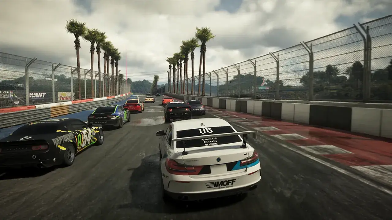 A pack of race cars on a wet, palm-lined circuit in GTA VI.